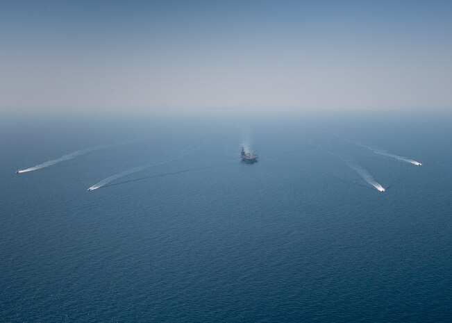 The aircraft carrier USS Nimitz (CVN 68) sails in the Arabian Gulf with the Royal Bahrain Naval Force ship Al-Fadhel, Mark VI patrol boats attached to Task Force (TF) 56 and Bahrain Coast Guard ships, Oct. 11. TF 56 and the Nimitz Carrier Strike Group are deployed to the U.S. 5th Fleet area of operations in support of naval operations to ensure maritime stability and security in the Central Region, connecting the Mediterranean and Pacific through the Western Indian Ocean and three critical chokepoints to the free flow of global commerce.