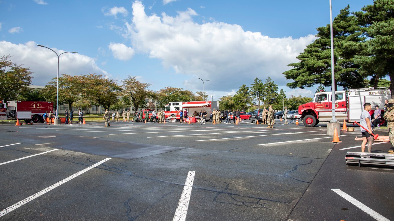 Participants of the 2020 Fire Muster interact with 35th Civil Engineer Squadron fire department firefighters and the equipment they use at Misawa Air Base, Japan, Oct. 6, 2020. The 35th CES fire department hosted Fire Prevention Week to raise awareness about fire safety. (U.S. Air Force photo by Airman 1st Class China M. Shock)