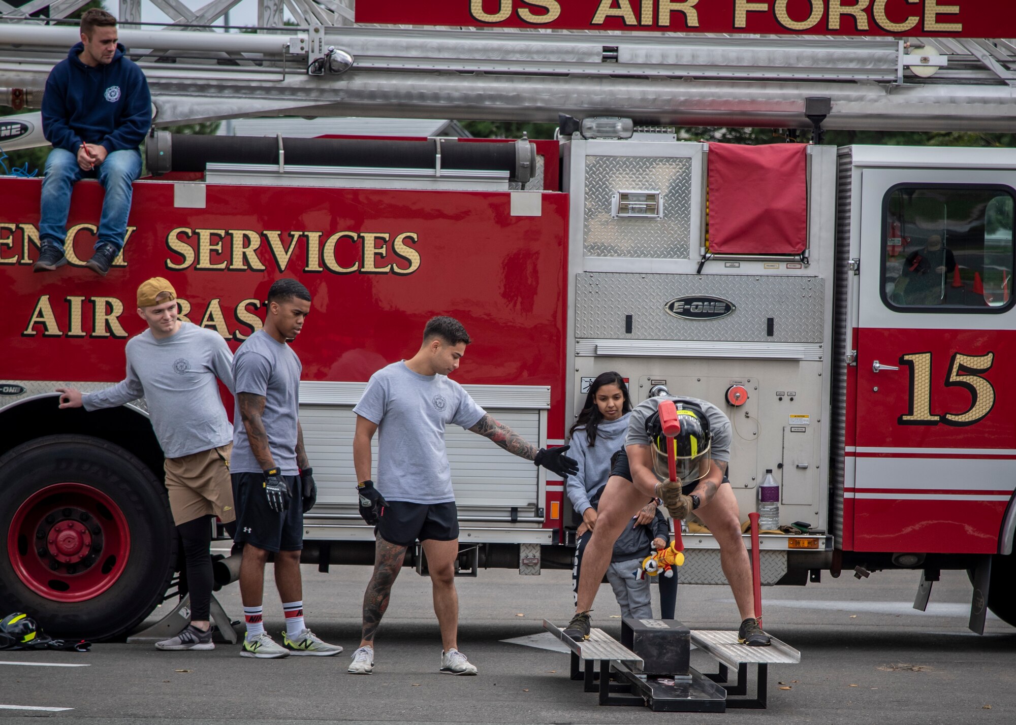 A participant hits a Kaiser sled during the Fire Prevention Week open house, at Misawa Air Base, Japan, Oct. 10, 2020. Fire musters give Airmen from different career fields across the wing an opportunity to test their fitness abilities against one another while experiencing tasks a firefighter would conduct during an emergency. During the event, 35th Civil Engineer Squadron firefighters educated base community members on fire prevention in order to promote a fire-safe lifestyle. (U.S. Air Force photo by Airman 1st Class China M. Shock)
