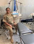 Kentucky National Guard Maj. Mitisha Martin poses Aug. 20, 2020, in Poland with the 1163rd Area Support Medical Company’s motto: “Whatever it takes.”
