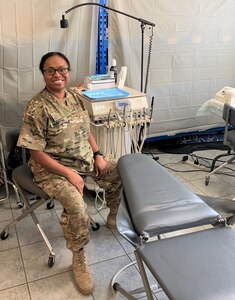 Kentucky National Guard Maj. Mitisha Martin poses Aug. 20, 2020, in Poland with the 1163rd Area Support Medical Company’s motto: “Whatever it takes.”