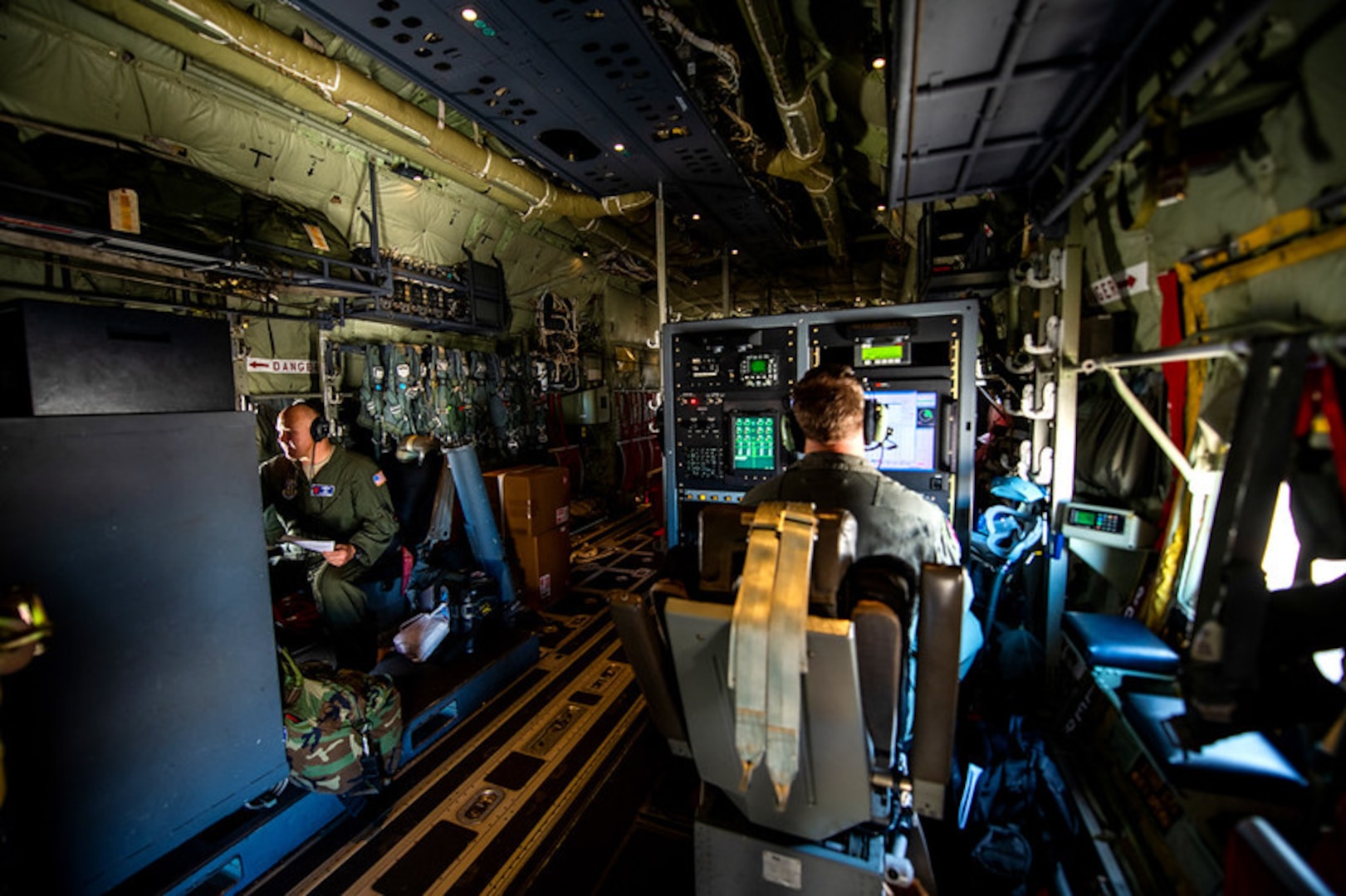 U.S. Air Force Lt. Col. Kyle Larson (left), 53rd Weather Reconnaissance Squadron air reconnaissance weather officer, and Master Sgt. Ed Scherzer (right), weather reconnaissance load master, both from Keesler Air Force Base, Miss., prepare for take off in support of hurricane evacuation operations during hurricane Delta Oct. 8, 2020, at Joint San Antonio-Kelly Field, Texas.