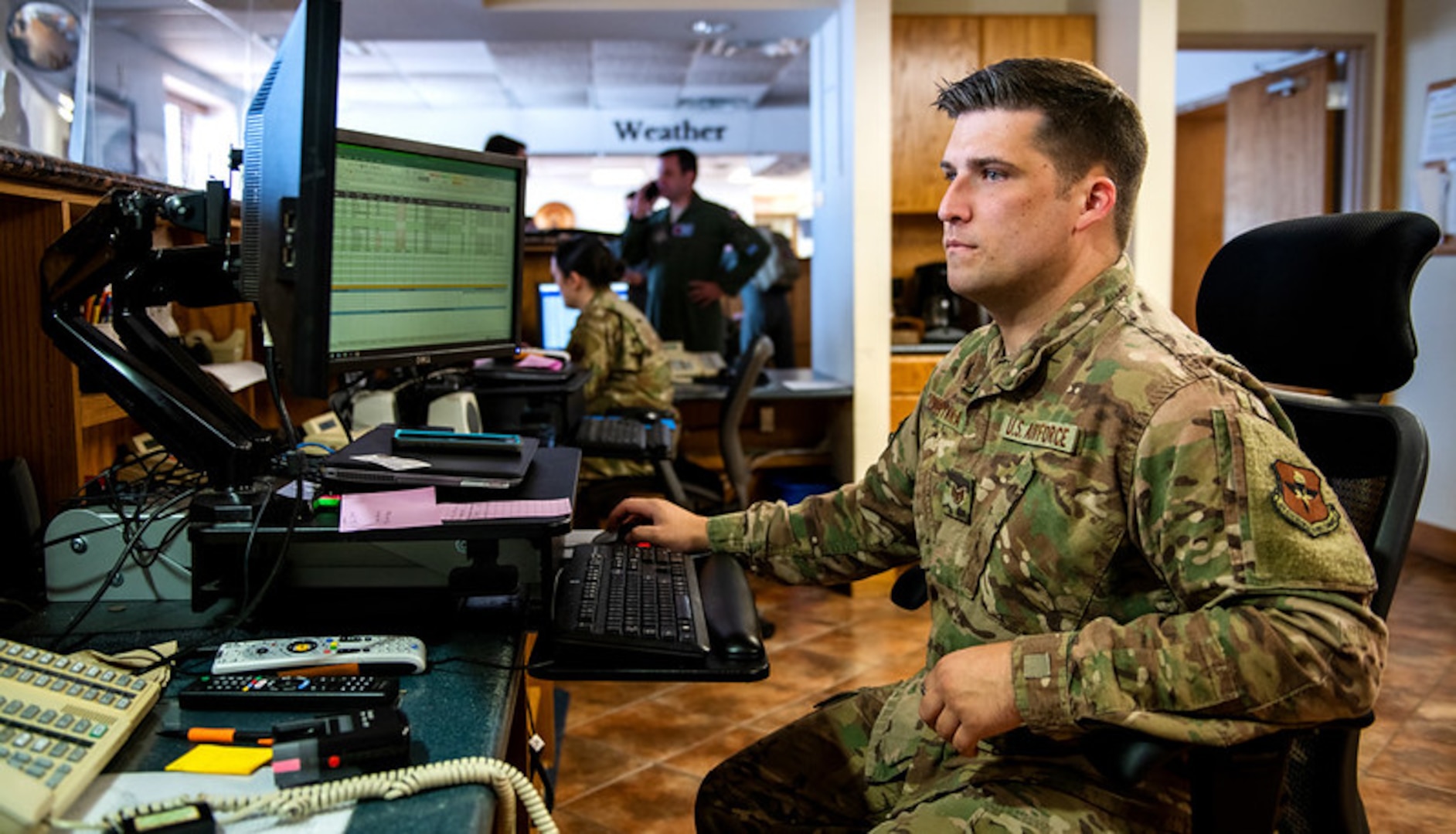 Staff Sgt. Tyler, 502nd Operations Support Squadron airfield management, looks up information for C-130 air crews in support of hurricane evacuation operations during hurricane Delta Oct. 7, 2020, at Joint San Antonio-Kelly Field, Texas.