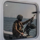 201015-N-KC128-0130 NAVAL SUPPORT ACTIVITY BAHRAIN (Oct. 15, 2020) - A Sailor assigned to Commander, Task Force (CTF) 56 stands security watch aboard a Mark VI patrol craft during an underway in the Arabian Gulf, Oct. 15. CTF 56 is responsible for the planning and execution of expeditionary missions in the U.S. 5th Fleet area of operations in support of naval operations to ensure maritime stability in the Central Region, connecting the Mediterranean and Pacific through the Western Indian Ocean and three strategic chokepoints to the free flow of global commerce. (U.S. Navy photo by Mass Communication Specialist 1st Class Daniel Hinton)