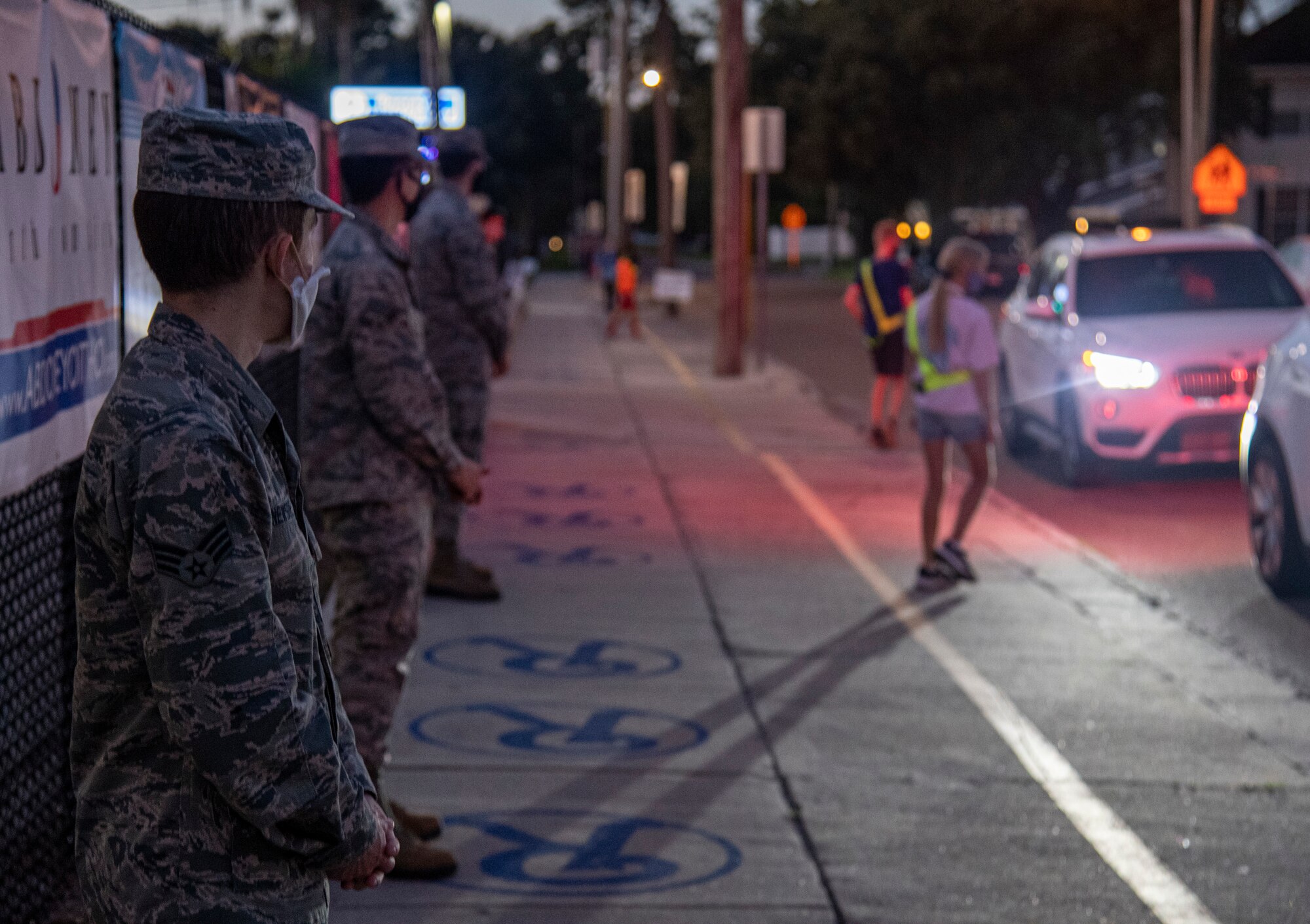 Members of Team MacDill stand in front of Roosevelt Elementary to greet students on their way to school in Tampa, Fla., Oct. 15, 2020.