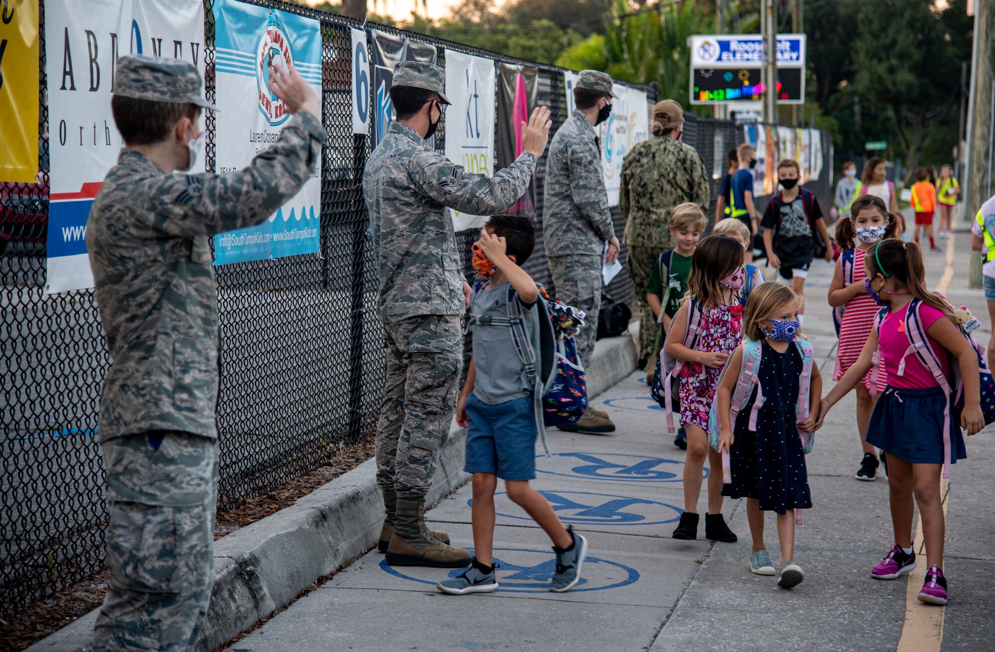 Members of Team MacDill greet students on their way to school at Roosevelt Elementary in Tampa, Fla., Oct. 15, 2020.