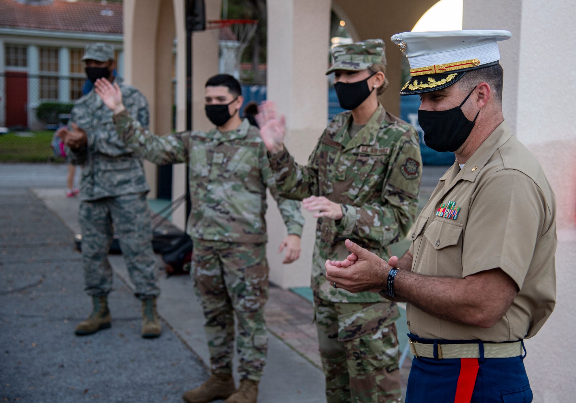 Members of Team MacDill greet students on their way to school at Roosevelt Elementary in Tampa, Fla., Oct. 15, 2020.