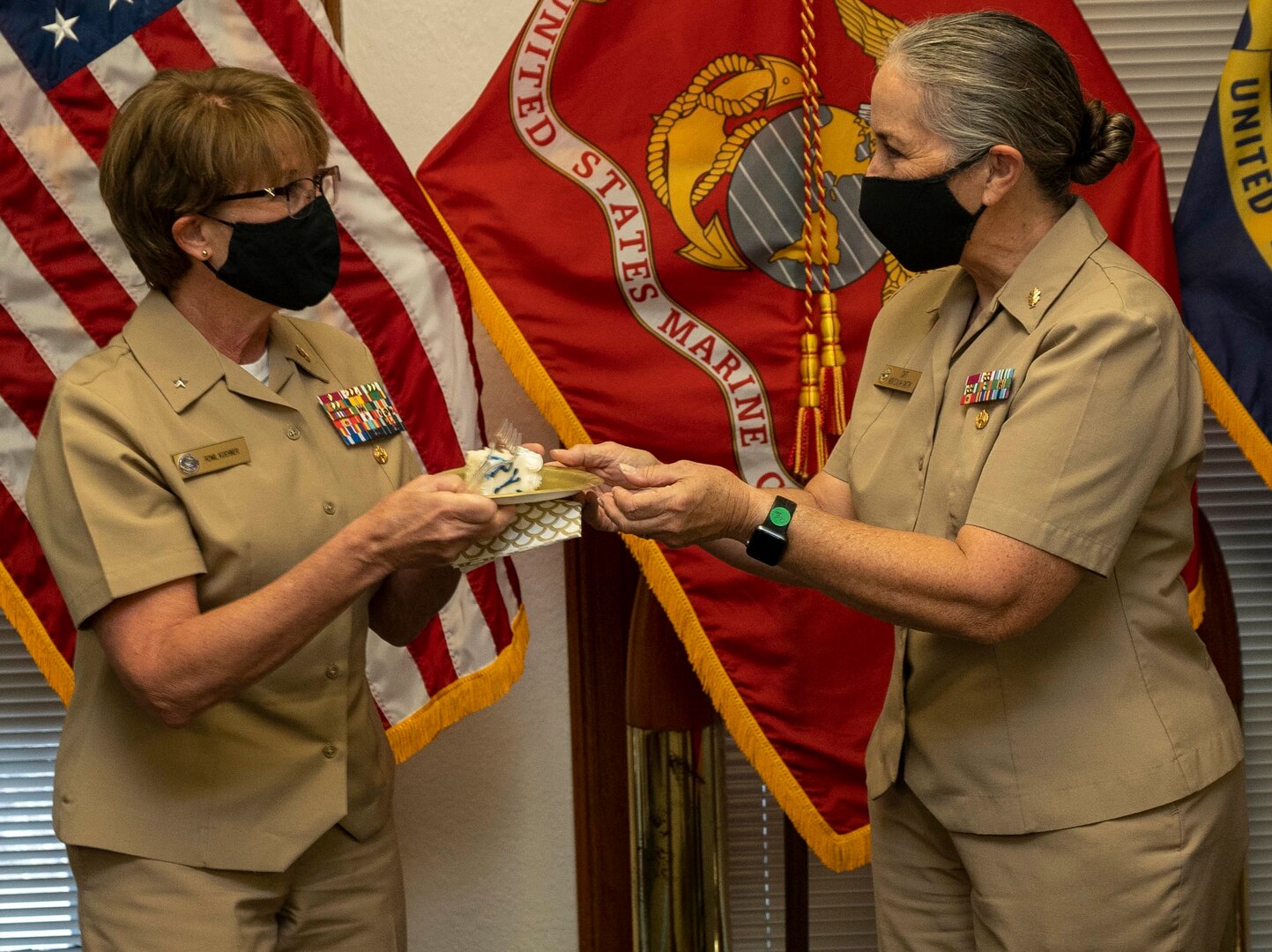 Rear Adm. Cynthia Kuehner (left), commander of Naval Medical Forces Support Command, receives the first slice of cake from Capt. Elizabeth Montcalm-Smith (right), the senior Sailor at NMFSC, during a ceremonial cake cutting to honor the Navy’s 245th birthday at Joint Base San Antonio-Fort Sam Houston Oct. 13.