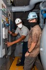 Environmental Zone Manager Patrick Williams (Code 990E) and Industrial Equipment Work Leader Ricky McCadden (Code 990E) working together in the new tank space.