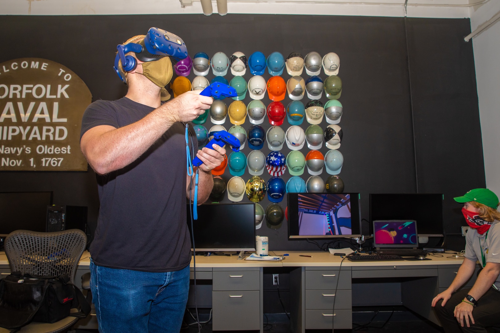 NNSY Photographer Danny DeAngelis test drives the virtual reality simulation in the NNSY Technology and Innovation Lab while Assistant Shift Test Engineer Joey Hoellerich stands by to assist.