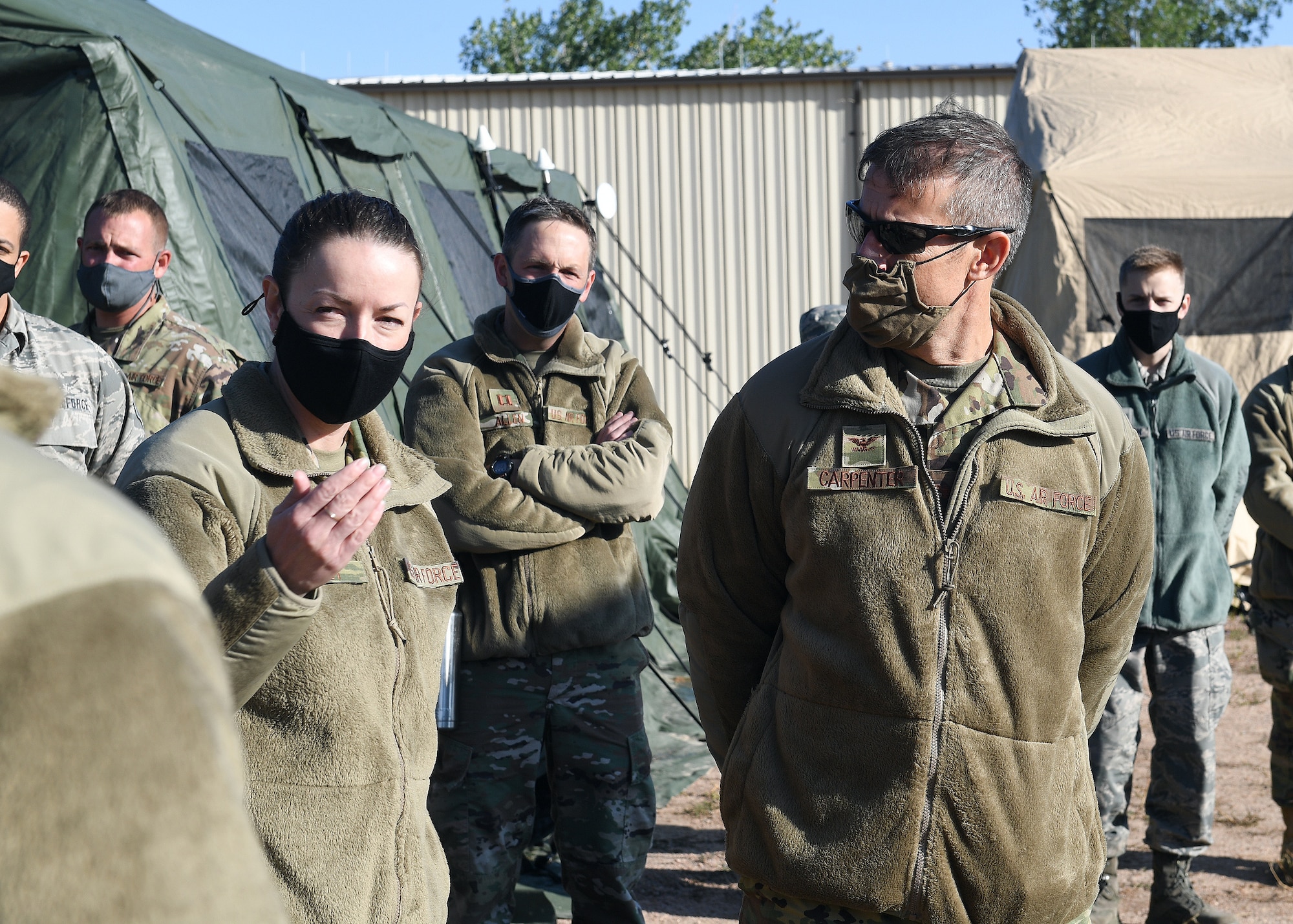 Lt. Col. Elizabeth Paget, 379th Space Range Squadron commander, shares remarks alongside Col. Sean Carpenter, 926th Wing commander, on the morning of Sept. 11, at the United States Air Force Academy's Field Engineering Readiness Laboratory, Colorado. The group took a tactical pause during 379th SRS Field Training Exercise in observance of the 19th anniversary of the 9/11 attacks. (U.S. Air Force photo by Dennis Rogers)