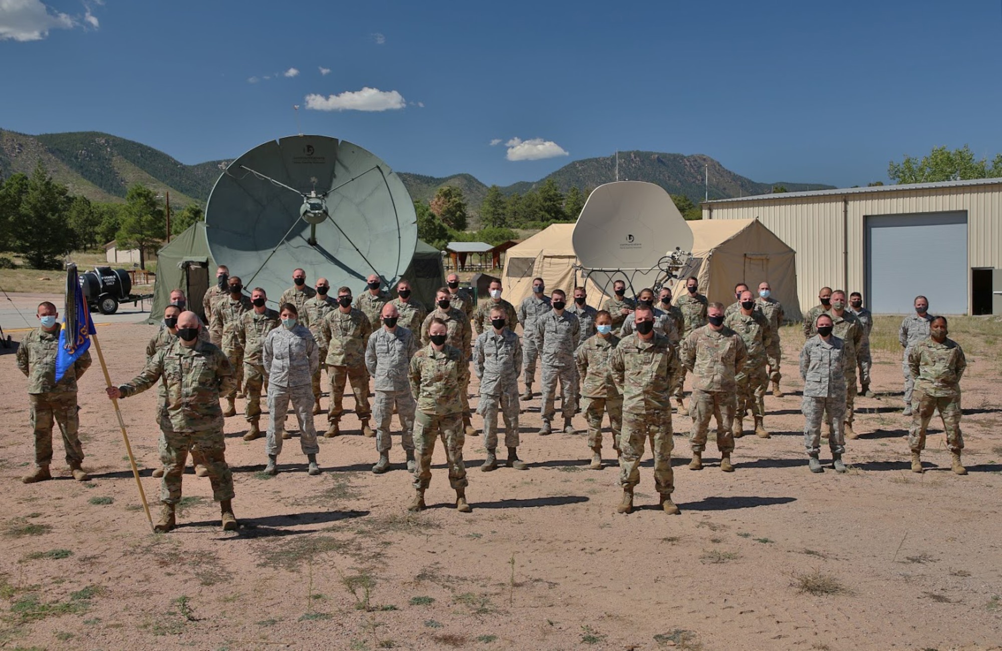 The 379th Space Range Squadron poses in front of their deployable mission equipment during the 379th SRS Field Training Exercise, Sept. 10-13, 2020, at the United States Air Force Academy's Field Engineering Readiness Laboratory, Colorado. Despite obstacles, this event marked the 379th SRS’s first major training exercise during the COVID-19 pandemic. (U.S. Air Force photo by Capt. Jordan Wind)