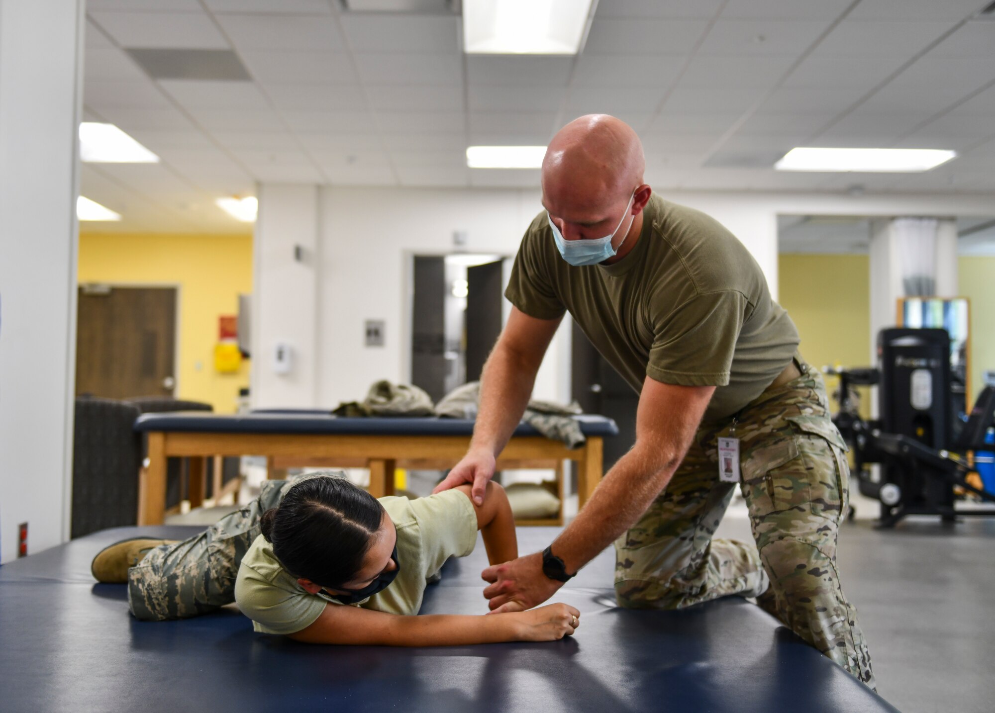 U.S. Air Force Staff Sgt. Joseph McFatter, 325th Medical Group physical therapy technician, helps a 325th Fighter Wing Airmen with a stretch at Tyndall Air Force Base, Florida, Oct. 08, 2020. The 325th MDG physical therapy clinic helps active duty members on their road to recovery with injuries and improving their overall health. (U.S. Air Force photo by Staff Sgt. Stefan Alvarez)