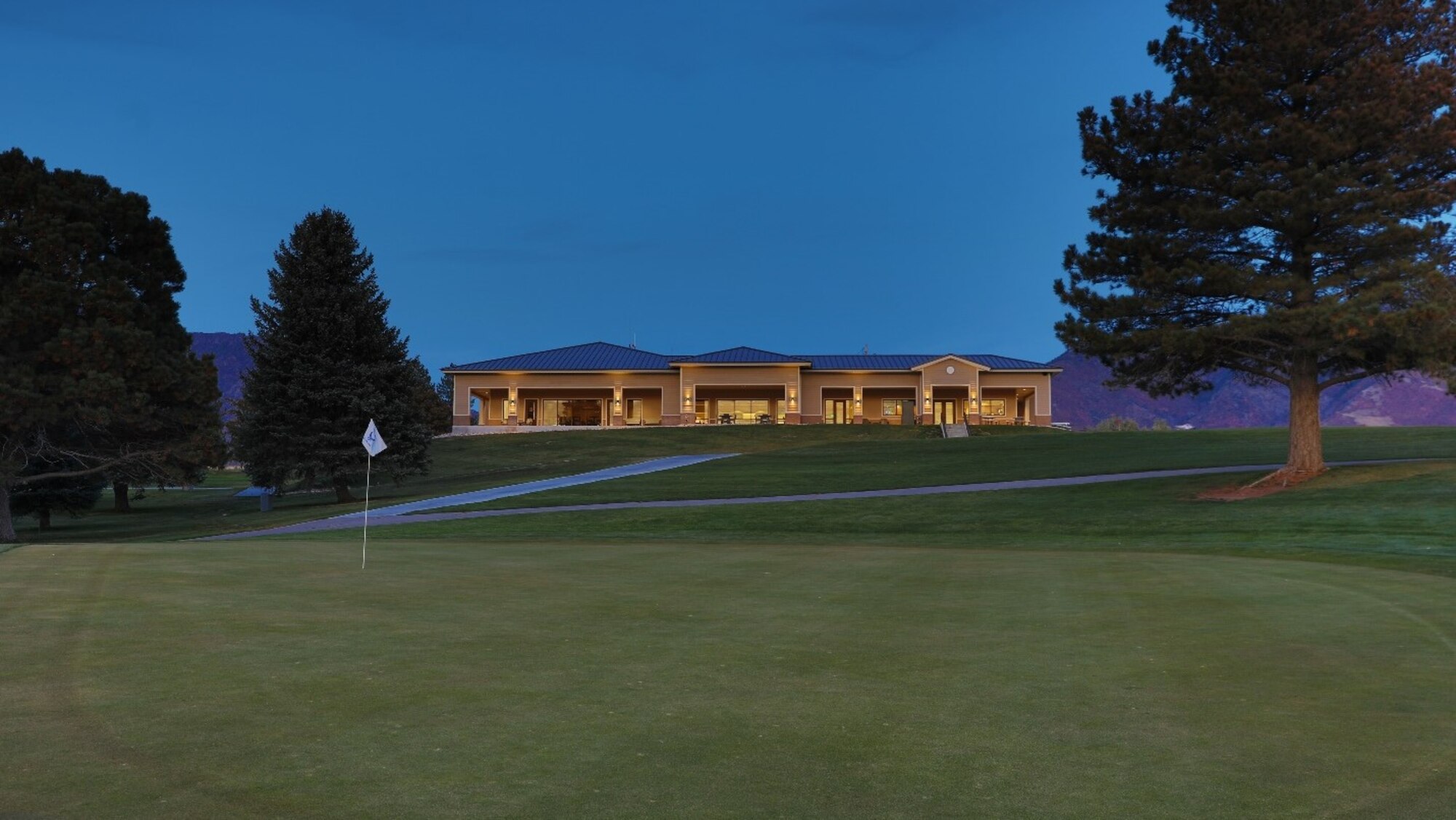 The front of the clubhouse viewed from the fairway in front of the golf course.
