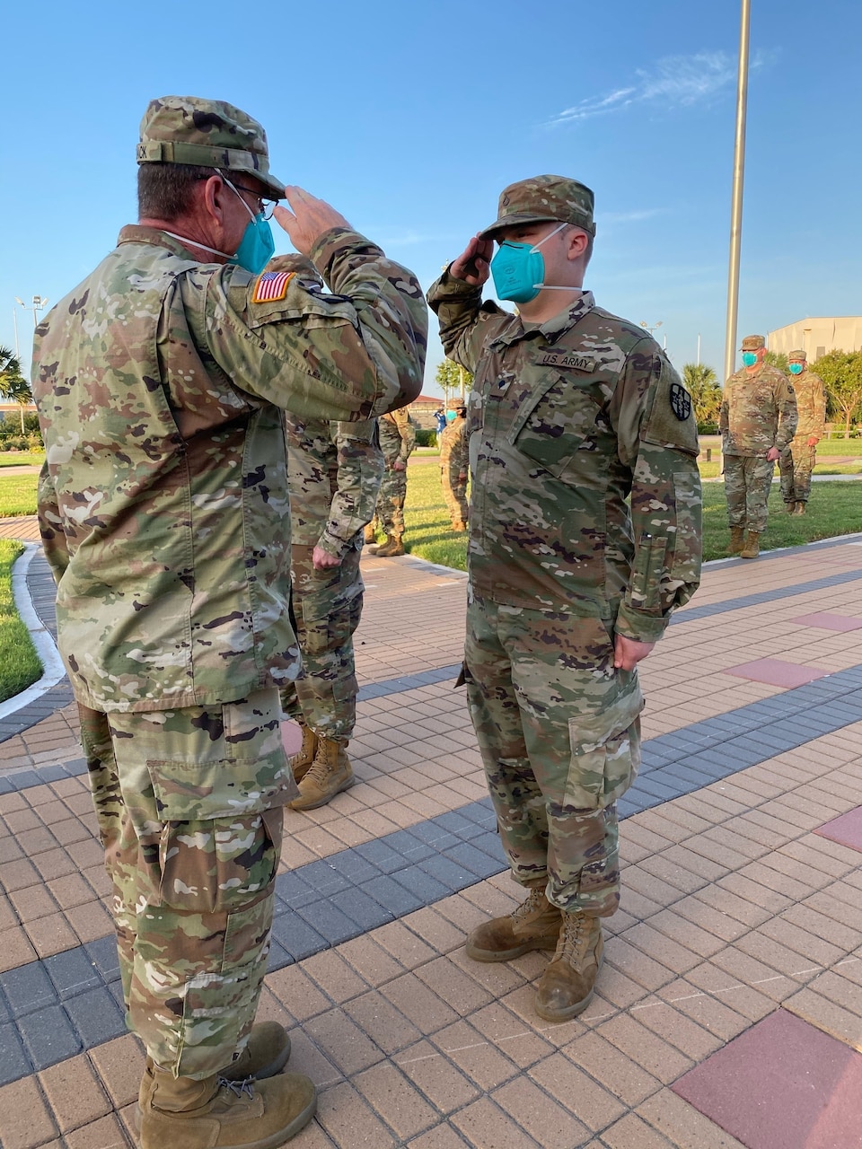 A soldier being saluted by another soldier.