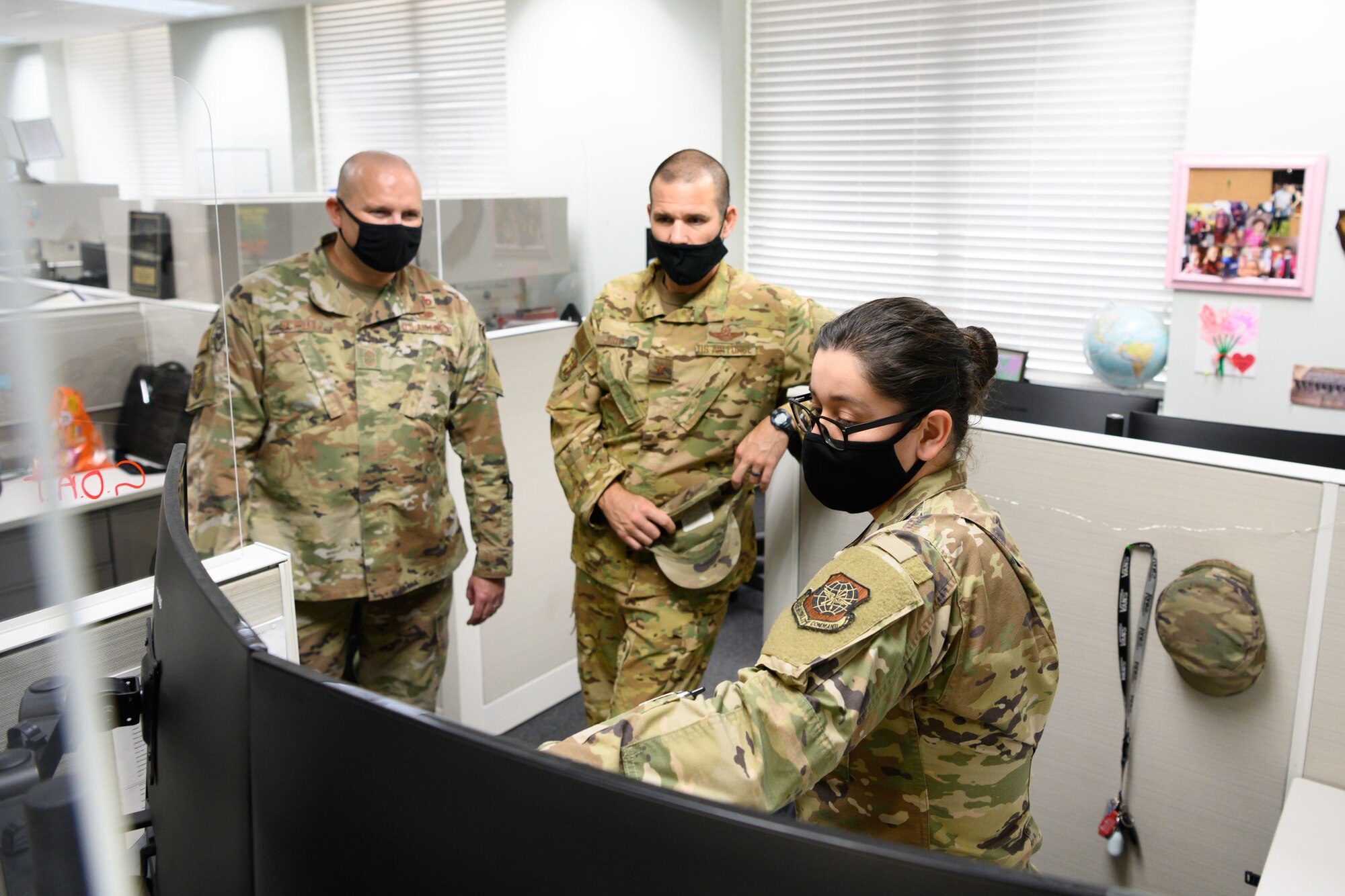 Finance team receives coin from vice wing commander and command chief.