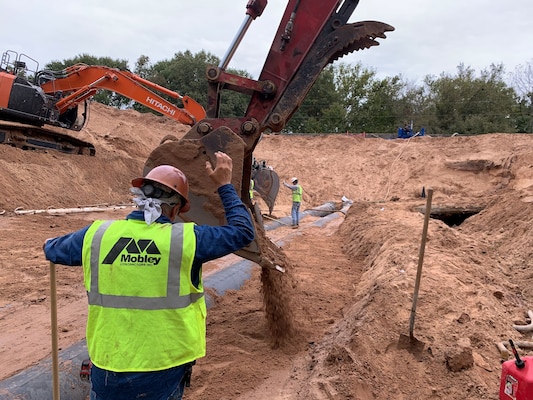 workers repairing a levee in Atkins, Arkansas