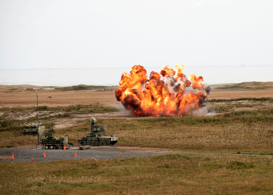 An explosion is seen on a grassy field