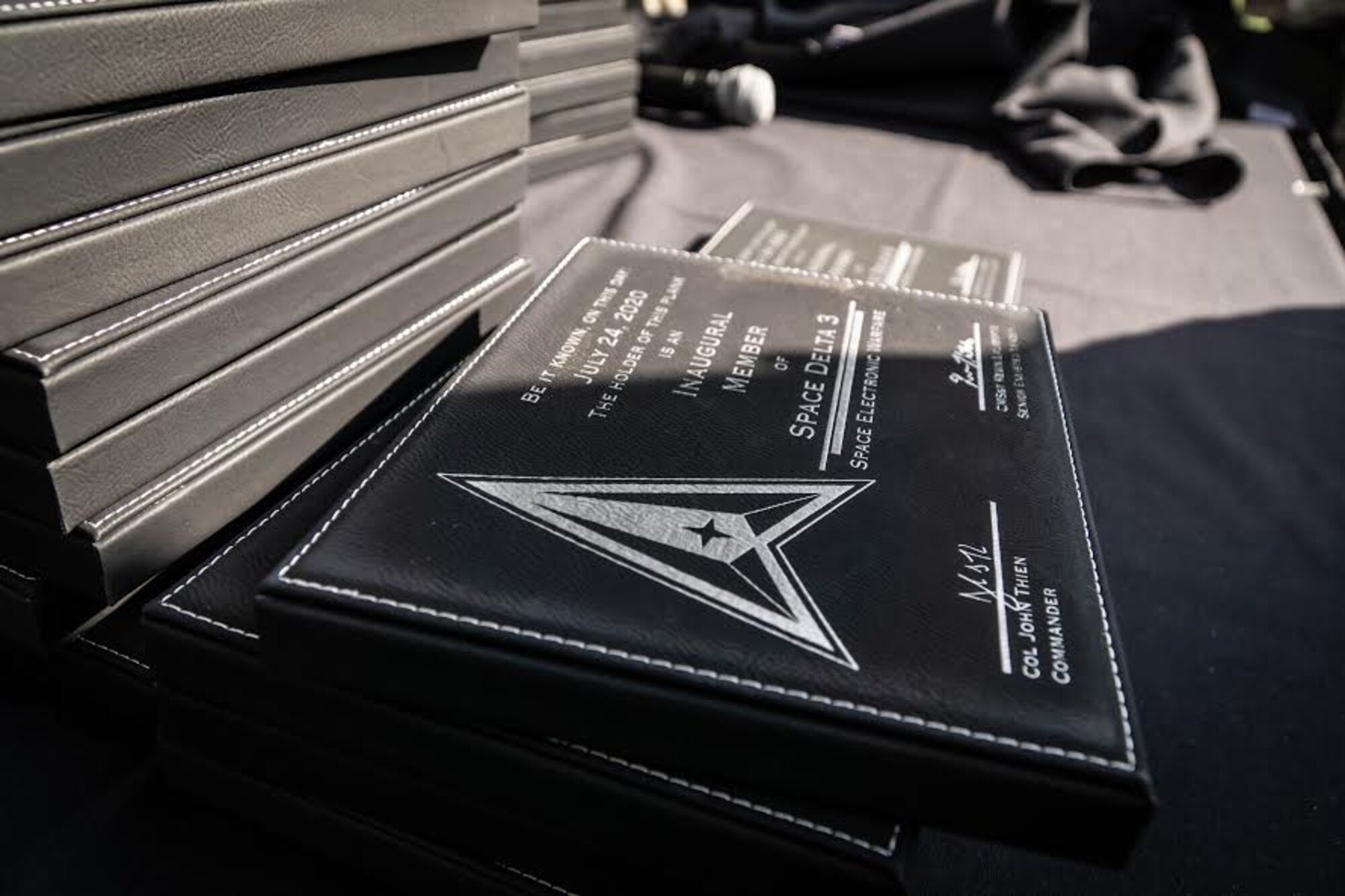 Delta 3 members receive planks commemorating their involvement in the unit's stand-up.