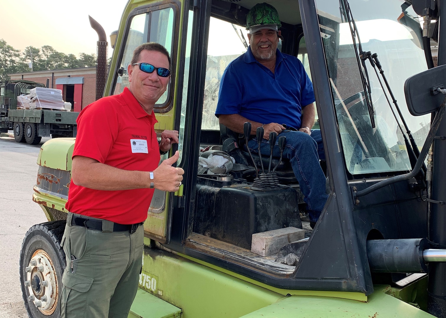 Detective Ben Parrish, Duplin County Sheriff’s Department, left, and Darryl Whaley, county garage supervisor, enjoy a moment with the forklift they acquired from DLA Disposition Services at Camp Lejeune, North Carolina.