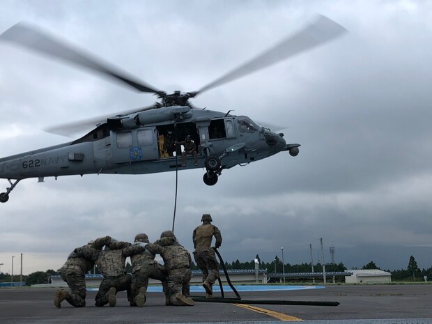 U.S. Marines conduct Helicopter Rope Suspension Techniques with U.S. Navy Helicopter Sea Combat Squadron 12 on the Combined Arms Training Center Camp Fuji Airfield, Sept. 16.