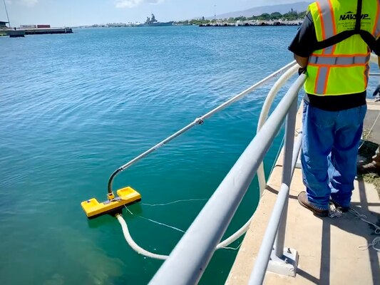 Naval Supply Systems Command Fleet Logistics Center Pearl Harbor practices emergency response during fuel spill prevention and response training.