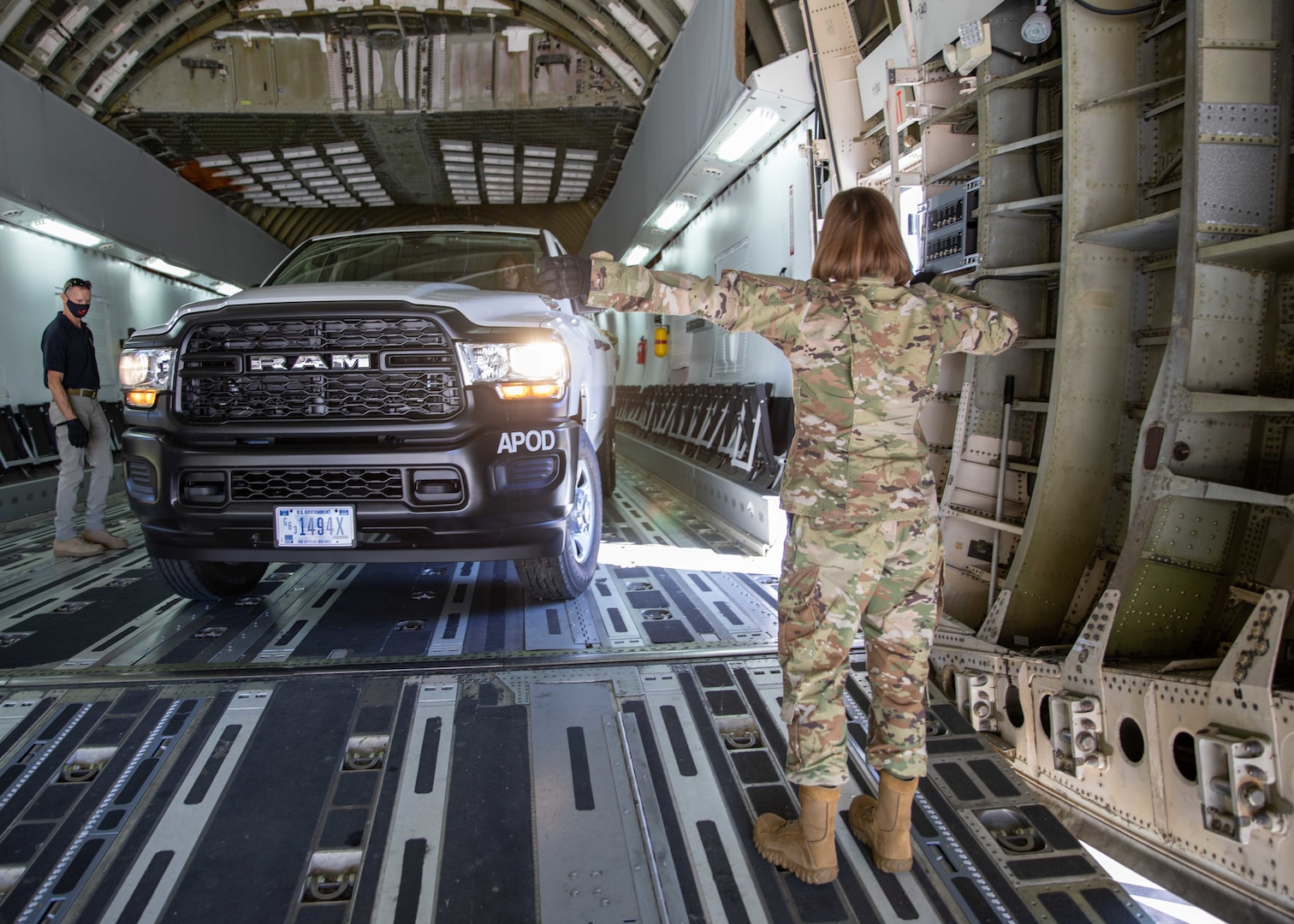 U.S. Air Force Master Sgt. Christina Anders, assigned to Joint Task Force Civil Support (JTF-CS), guides a fleet vehicle into a C-17 Globemaster III trainer at Fort Lee, Va. during load training as part of Exercise KODA.