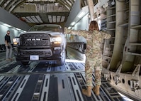 U.S. Air Force Master Sgt. Christina Anders, assigned to Joint Task Force Civil Support (JTF-CS), guides a fleet vehicle into a C-17 Globemaster III trainer at Fort Lee, Va. during load training as part of Exercise KODA.