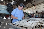 Ruben Pesina,12th Maintenance Group, repairs a panel from a T-38C Talon aircraft during a phase inspection at Joint Base San Antonio-Randolph. A trainer aircraft maintenance training center in Hangar 62 at JBSA-Randolph will soon be producing a new generation of trainer aircraft technicians to serve Air Education and Training Command.