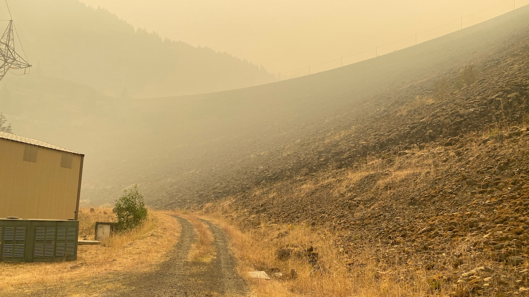 Smoke hangs heavy in the air around the main embankment at Cougar Dam Sept. 14, just days after the Holiday Farm Fire burned through the area, impacting Cougar and nearby Blue River Dam.