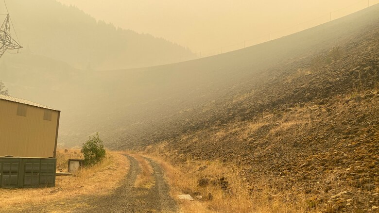 Smoke hangs heavy in the air around the main embankment at Cougar Dam Sept. 14, just days after the Holiday Farm Fire burned through the area, impacting Cougar and nearby Blue River Dam.