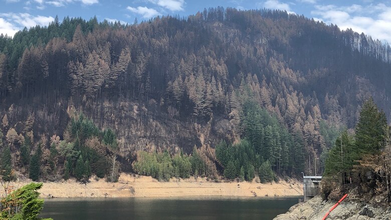 A view of the reservoir at Blue River Dam shows adjacent hillsides scorched by the Holiday Farm Fire, which started about an hour east of Eugene following historic winds that arrived in the area Sept. 7. The fire reached Blue River and nearby Cougar Dam.