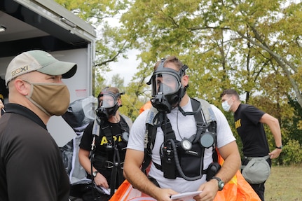 Members of the 52nd Civil Support Team (Weapons of Mass Destruction) discuss the plan to evaluate a suspected contaminated building during an exercise on Sept. 28, 2020, at the Fairfield County Airport in Carroll, Ohio.