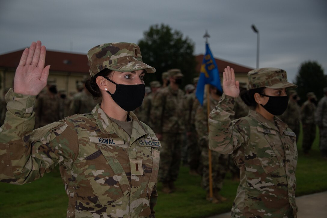 Space Force Second Lieutenants Amy Coba and Elizabeth Kowal, Officer Training School Class 20-08 graduates, raise their right hand and recite the Space Force Oath of Office