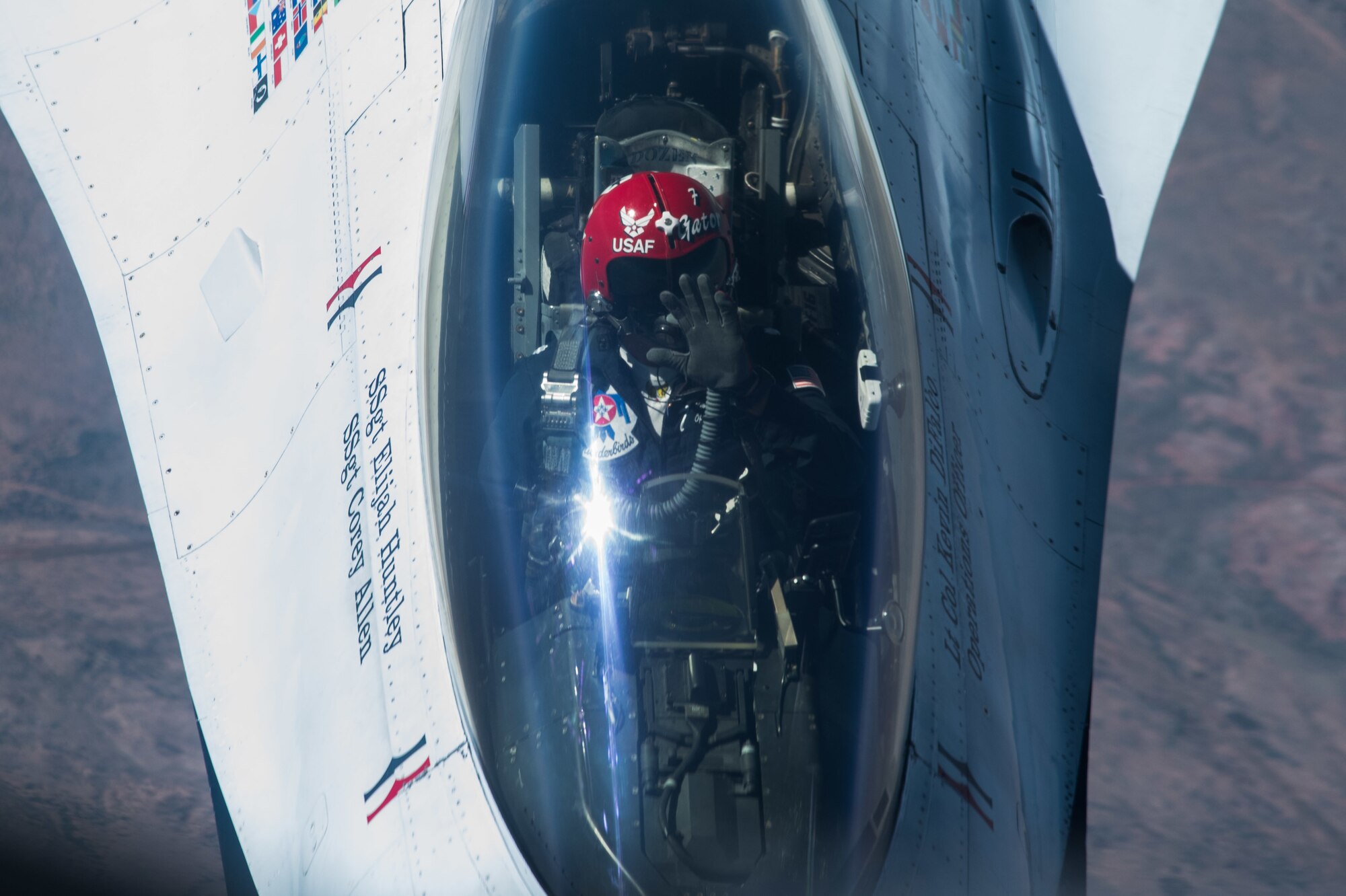 A pilot of an F-16 Fighting Falcon Thunderbird waves to Tech. Sgt. Bobby Jones, 350th Air Refueling Squadron in-flight refueling specialist, after receiving fuel from a KC-135 Stratotanker Oct. 15, 2020 through the skies of New Mexico. The Thunderbirds, the Air Force’s premier aerial demonstration team, were en route to the Bell Fort Worth Alliance Air Show in Fort Worth, Texas. (U.S. Air Force photo by Senior Airman Alexi Bosarge)