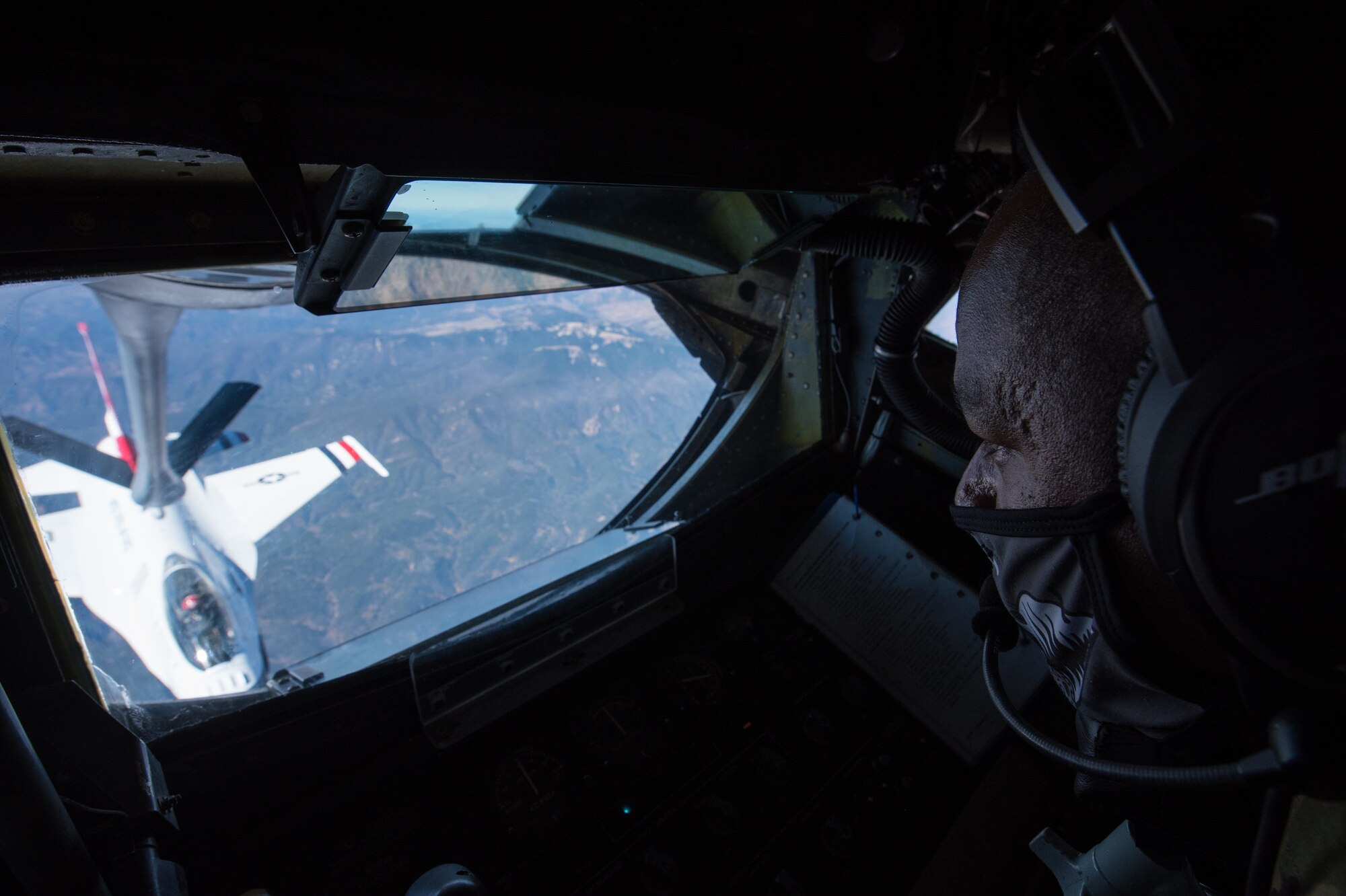 Tech. Sgt. Bobby Jones, 350th Air Refueling Squadron in-flight refueling specialist, uses the boom of a KC-135 Stratotanker to transfer fuel to an F-16 Fighting Falcon Thunderbird Oct. 15, 2020, through the skies of New Mexico. The KC-135 passed off fuel to the Thunderbirds, allowing for a quick, non-stop route between destinations. ((U.S. Air Force photo by Senior Airman Alexi Bosarge)