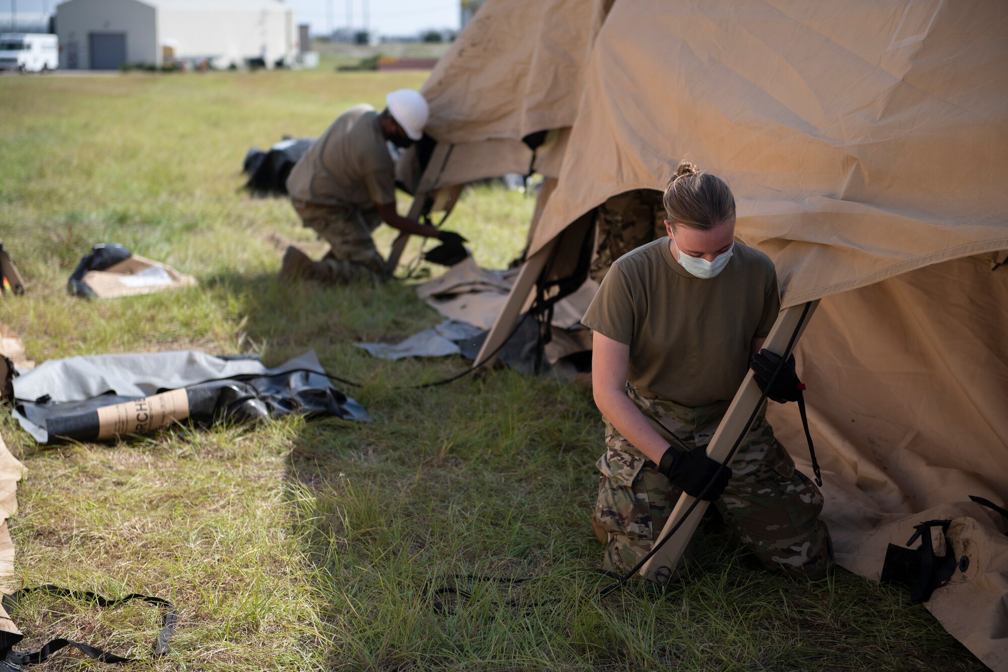 a woman stabilizes a tent rod