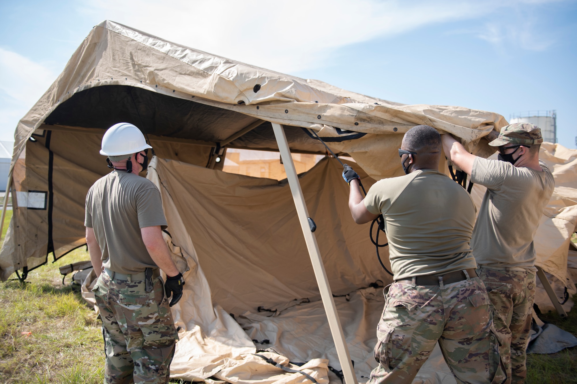 men raise a tent