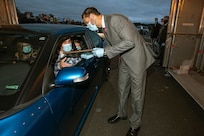 Aaron Crutchfield, left, Shop 26 Welders, receives his graduation certificate from Shop 26 superintendent Steven Dibert Oct. 16, 2020, during the annual Puget Sound Naval Shipyard &  Intermediate Maintenance Facility Apprentice School Graduation ceremony in "F Lot" on Naval Base Kitsap-Bremerton, Washington. (PSNS & IMF photo by Scott Hansen)