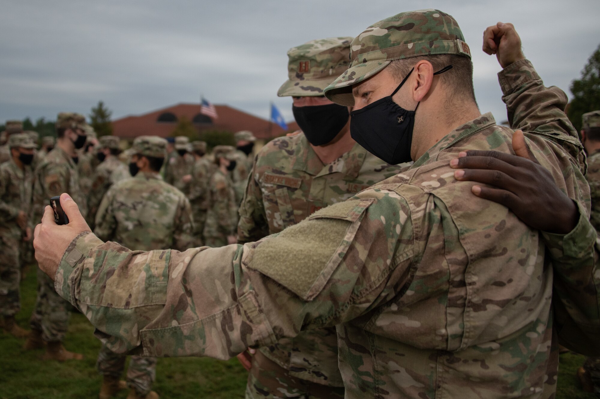 A newly commissioned Air Force officer video calls his friends and family after his Officer Training School graduation with his fellow classmates.