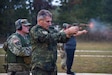 Bulgarian Chief of Defense Adm. Emil Eftimov fires the M-17 handgun, Oct. 8, at a small-arms pop-up range at Volunteer Training Site - Tullahoma. After signing a new training roadmap with the U.S., Bulgarian officials visited the Tennessee National Guard, renewing their partnership through 2030.