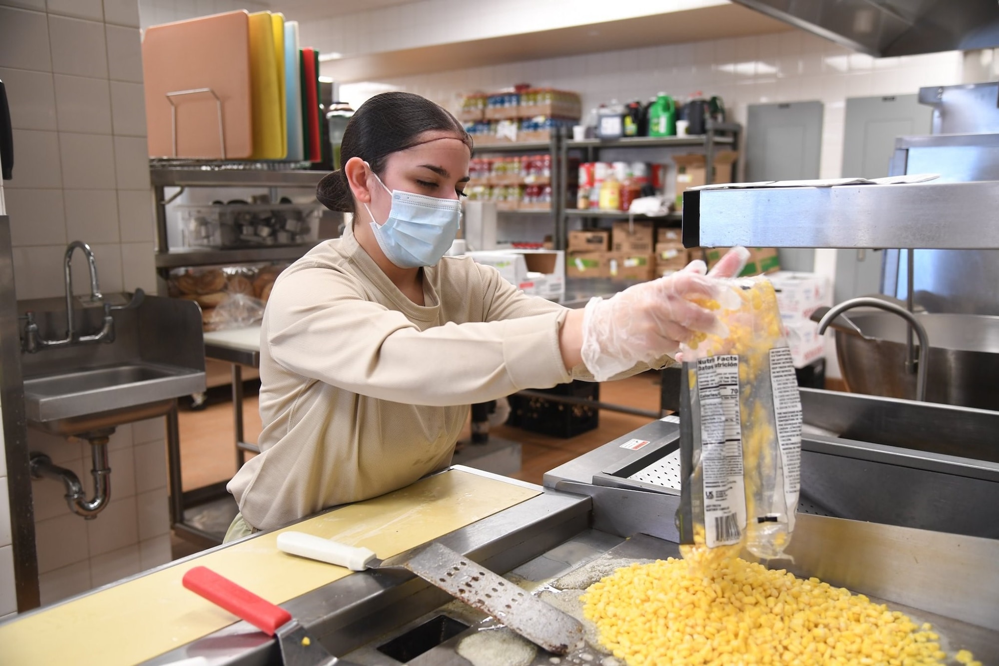 A1C Vanessa Alvarez, food assistant specialist from the 5th Force Support Squadron, is assisting the Prairie Vigilance exercise by working the Alert Diner on the flight line.