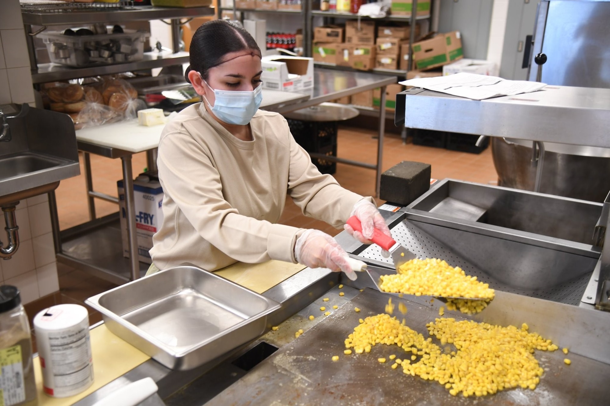 A1C Vanessa Alvarez, food assistant specialist from the 5th Force Support Squadron, is assisting the Prairie Vigilance exercise by working the Alert Diner on the flight line.