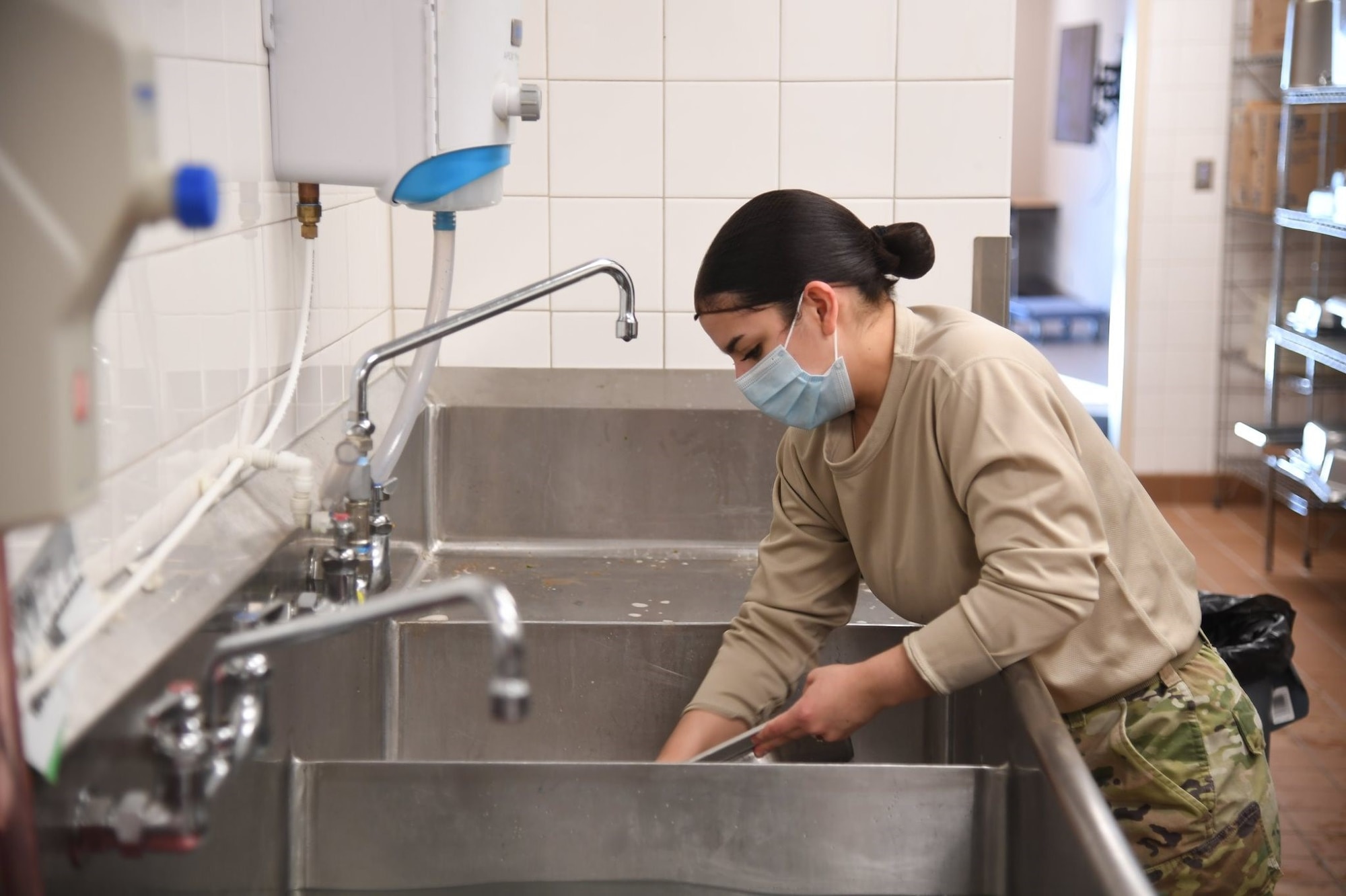 A1C Vanessa Alvarez, food assistant specialist from the 5th Force Support Squadron, is assisting the Prairie Vigilance exercise by working the Alert Diner on the flight line.