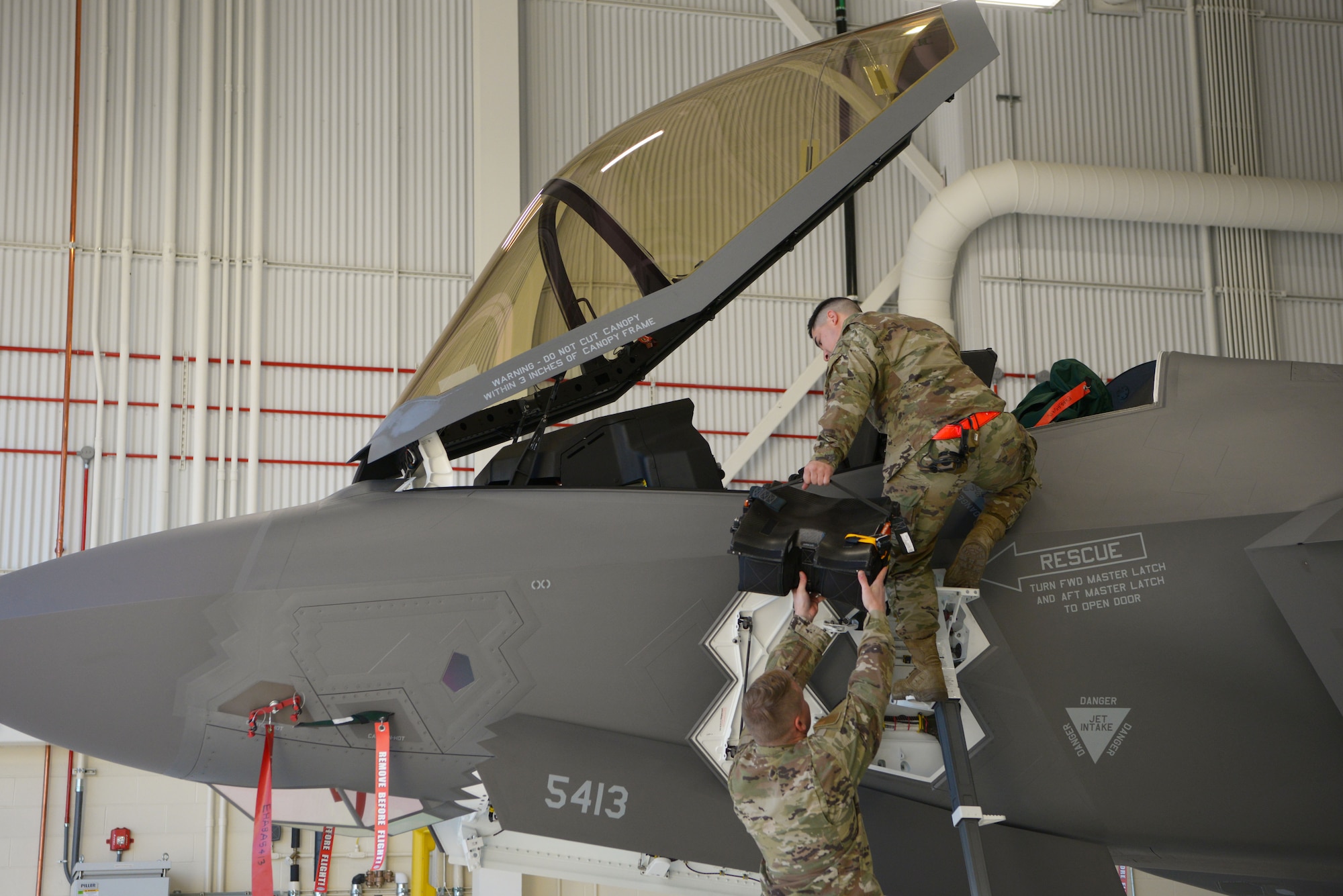 U.S. Air Force Staff Sgt. Victor Benitez, a 354th Maintenance Squadron (MXS) Aircrew Egress journeyman, and Tech. Sgt. Rylee James, a 354th MXS Aircrew Egress F-35A Lightning II cadre member, install the new arctic survival seat kit for the F-35A on Eielson Air Force Base, Alaska, Sept. 28, 2020.