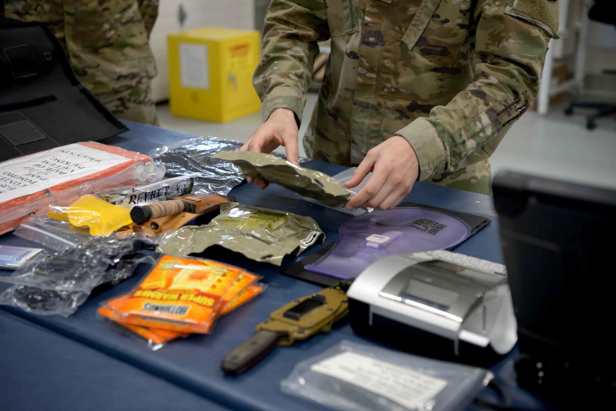 U.S. Air Force Staff Sgt. Ross Dugger, a 354th Operations Support Squadron Aircrew Flight Equipment craftsman, lays out the contents of the new arctic survival seat kit for the F-35A Lighting II on Eielson Air Force Base, Alaska, Sept. 25, 2020.