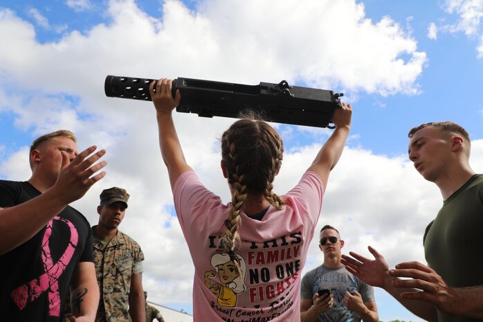 A U.S. Marine executes an overhead press with an M2 .50 caliber machine gun during the unit’s Warrior Week competition at Camp Lejeune, N.C., Oct. 15.