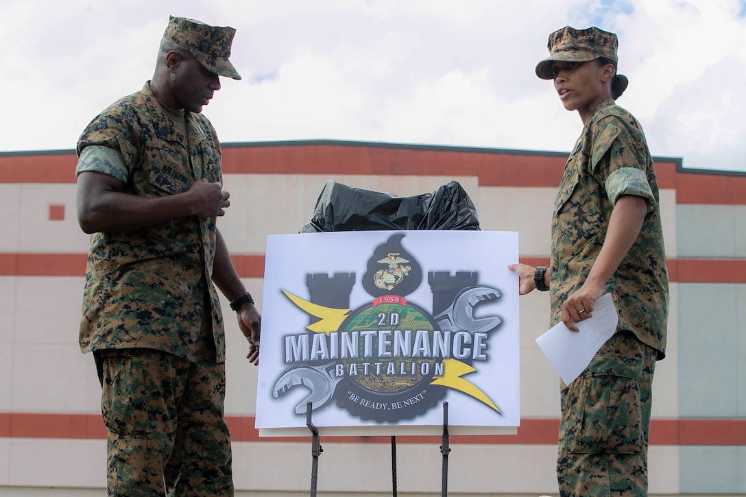 U.S. Marines unveil the new logo for 2nd Maintenance Battalion during the unit’s Warrior Week competition at Camp Lejeune, N.C., Oct. 16.