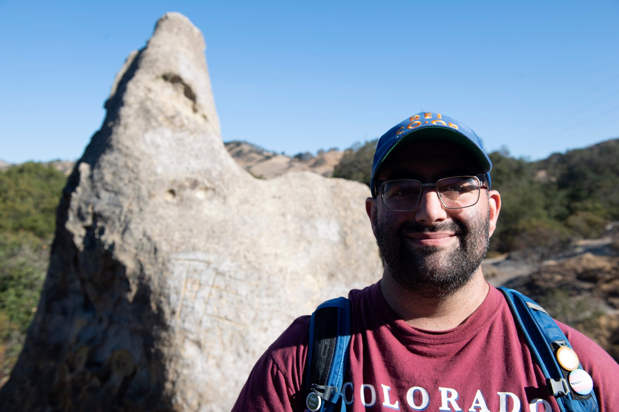 A man looks in to the camera and grins.