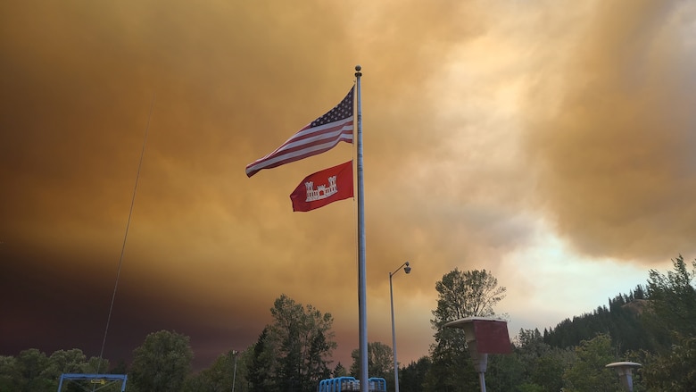The American and U.S. Army Corps of Engineers flags fly above Foster Dam Sept. 11 as heavy plumes of smoke from wildfires across the Willamette Valley dominates the horizon and the sky above.